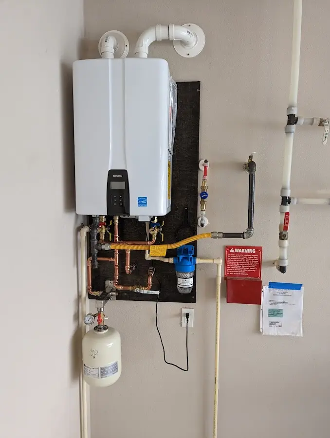 Professional plumber installing copper piping in a Ballston home